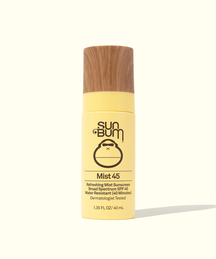 SPF 45 Sunscreen Face Mist in a yellow bottle with a wooden cap, offering sheer, lightweight protection from the sun, Sun Bum.