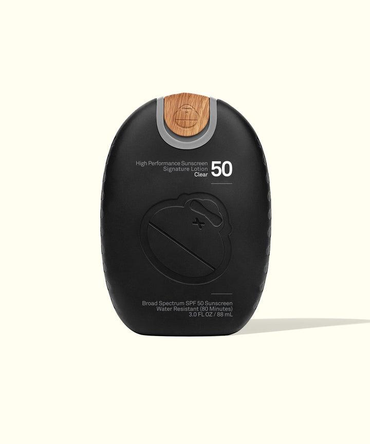 Signature SPF 50 Sunscreen Lotion | Mineral-based, Broad Spectrum protection, non-greasy, water-resistant formula in a sleek black bottle with wooden accent | Sun Bum