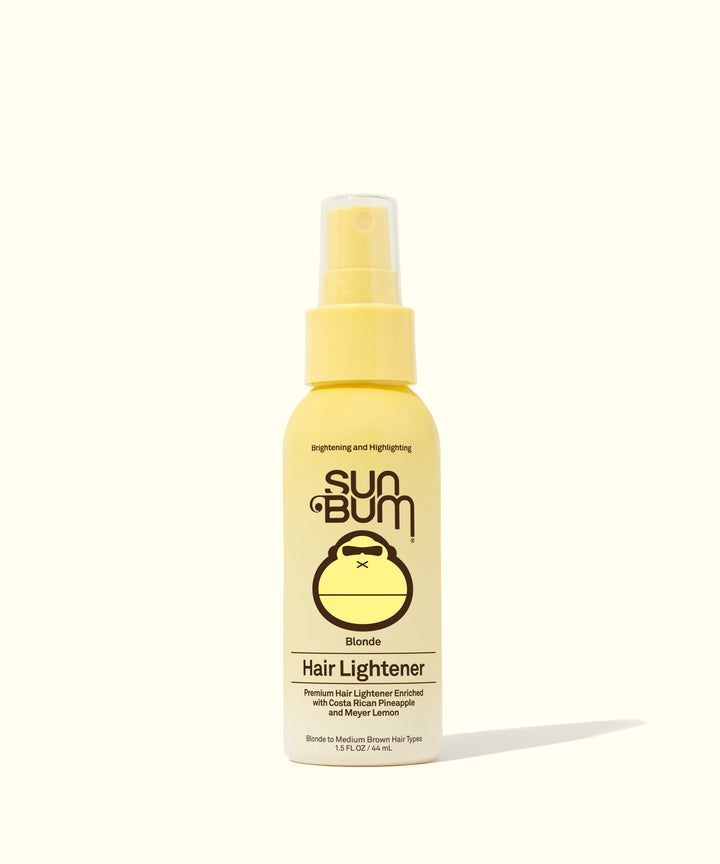 A yellow bottle of Sun Bum Blonde Hair Lightener spray made with Costa Rican Pineapples and Meyer Lemons to naturally brighten hair in the sun. Sun Bum.