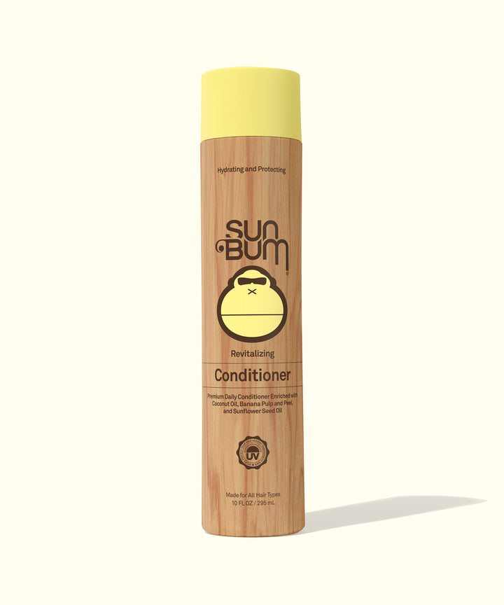 Revitalizing Conditioner bottle featuring hydrating and nourishing ingredients like Coconut Oil, Banana, and Sunflower Seed Oil, making hair smooth and healthy. Sun Bum,