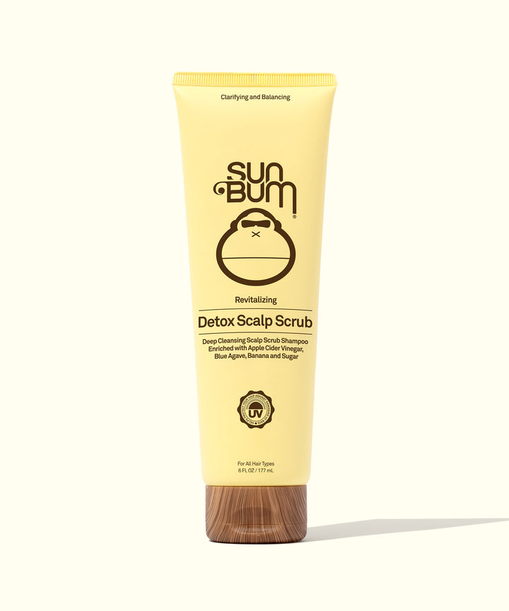 Yellow tube of Revitalizing Detox Scalp Scrub by Sun Bum, enriched with Apple Cider Vinegar, Sugar, and Blue Agave, designed to cleanse and exfoliate the scalp, breaking down product buildup, dirt, and excess oil.