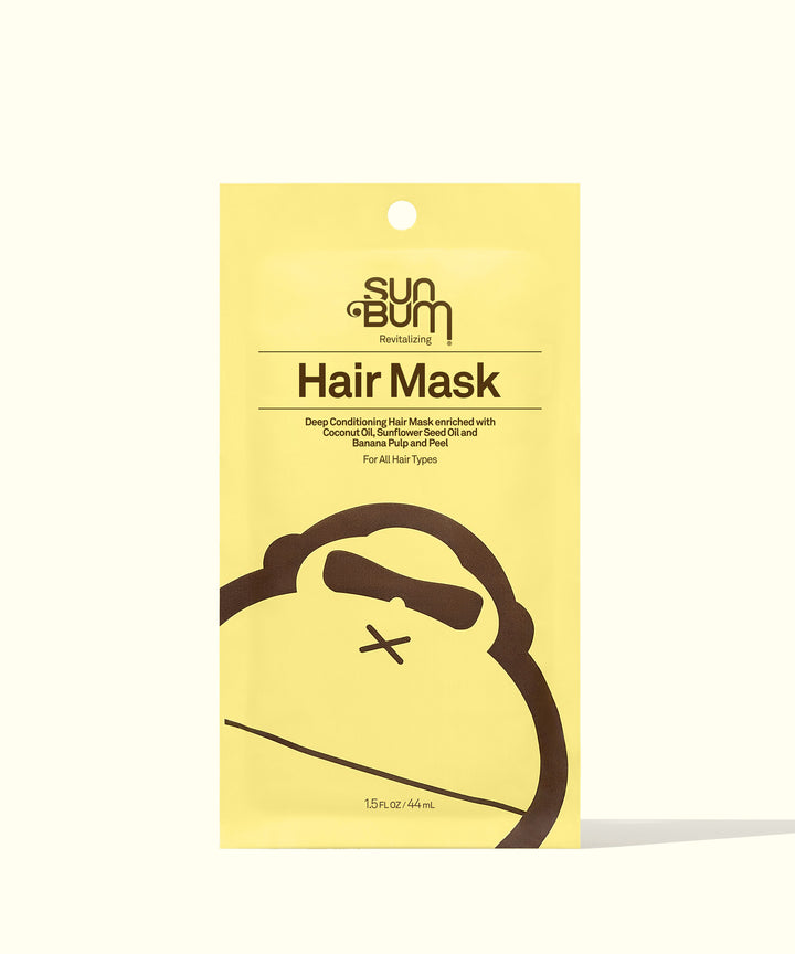 Yellow packaging of the Revitalizing Hair Mask by Sun Bum, a deep conditioning treatment for nourishing dry, damaged, and over-processed hair, with a friendly monkey logo at the bottom.
