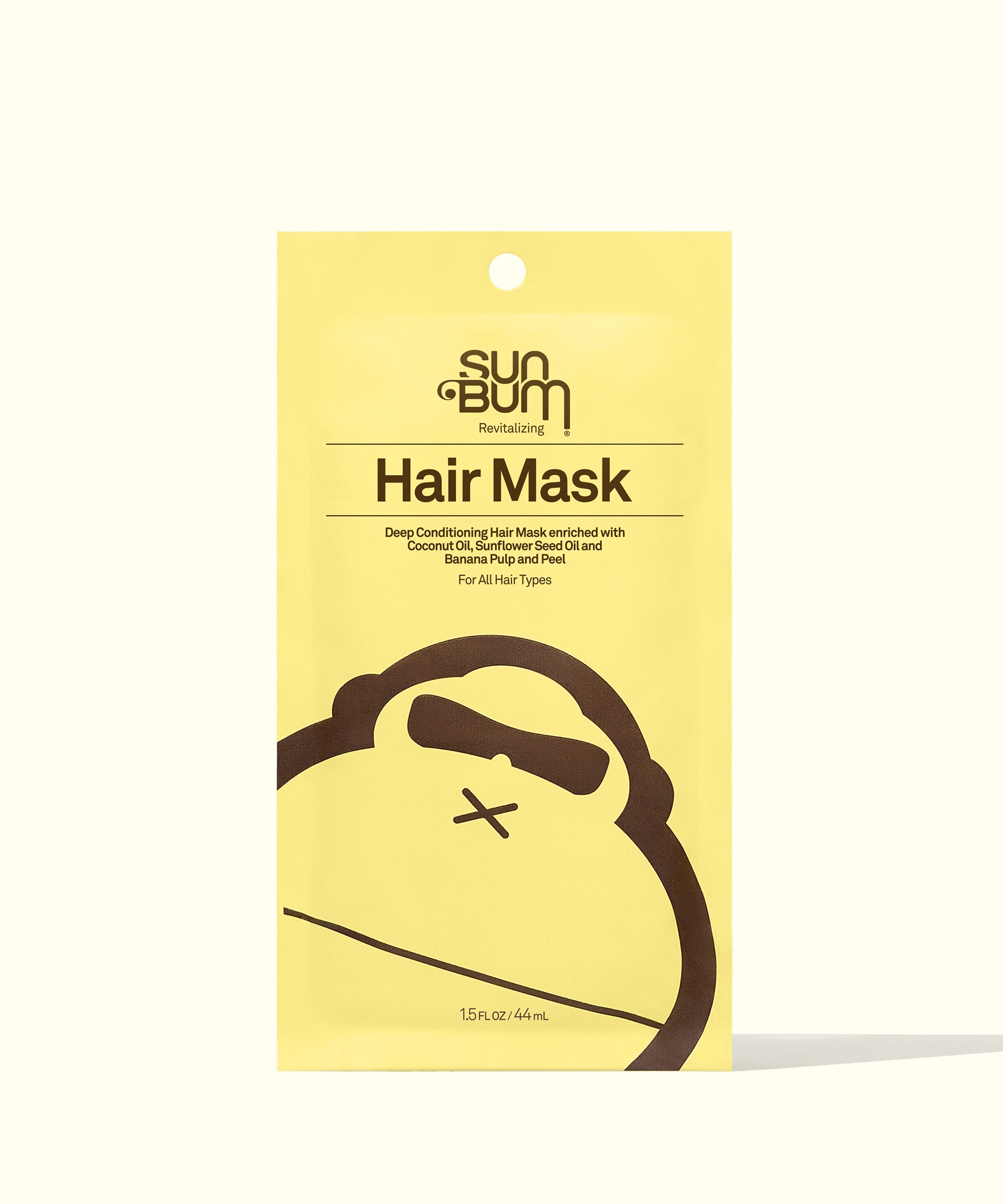 Yellow packaging of the Revitalizing Hair Mask by Sun Bum, a deep conditioning treatment for nourishing dry, damaged, and over-processed hair, with a friendly monkey logo at the bottom.