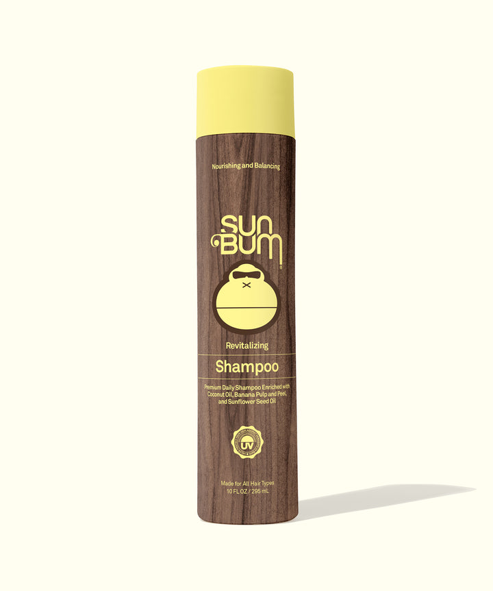Sun Bum Revitalizing Shampoo bottle featuring Coconut Oil, Banana, and Sunflower Seed Oil for deep nutrition and intense moisture.