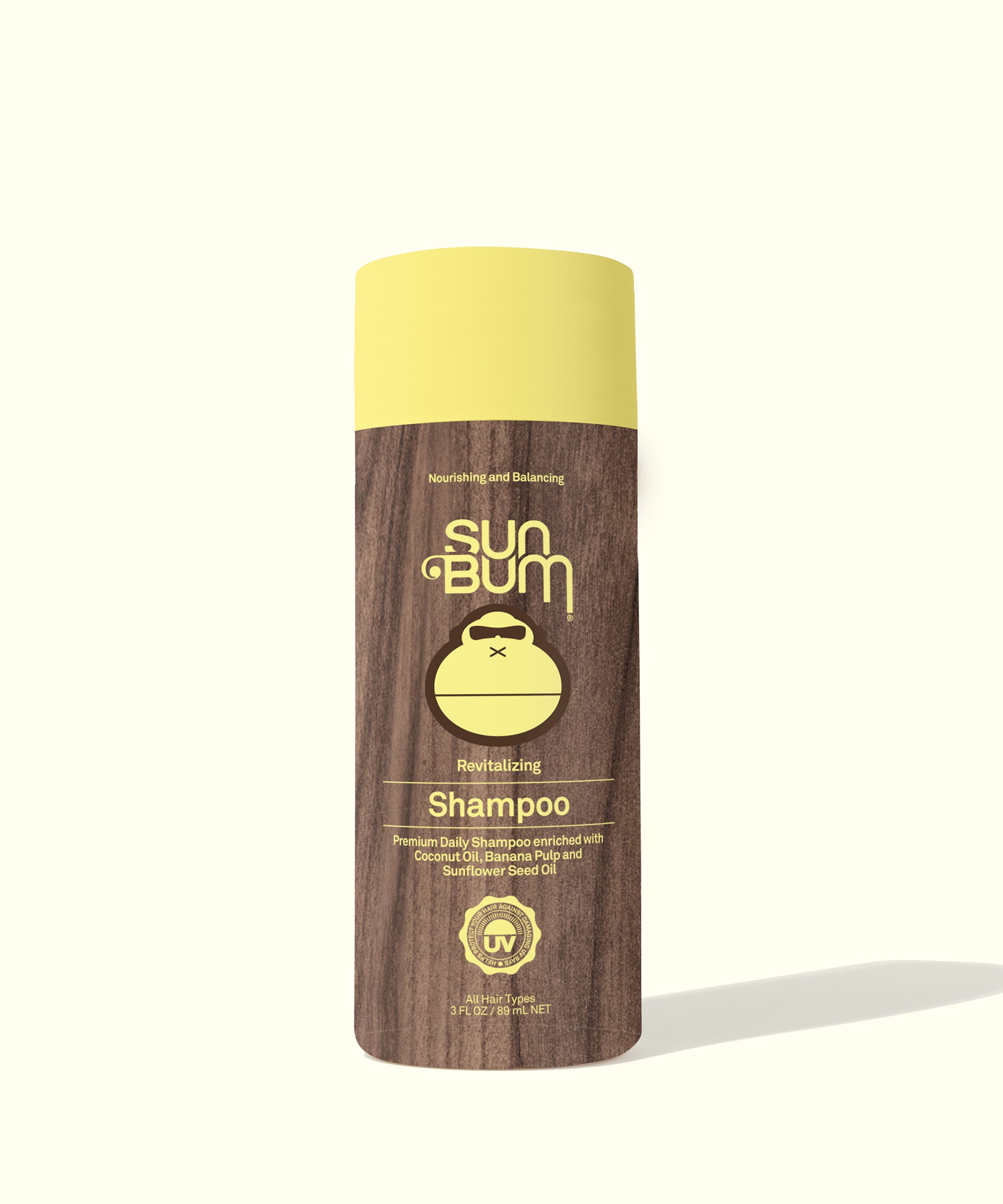 Revitalizing Shampoo bottle with a wooden design label, enriched with Coconut Oil, Banana, and Sunflower Seed Oil for deep nutrition, Sun Bum.