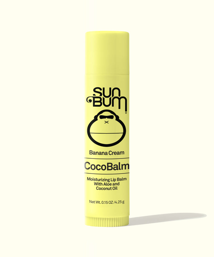 Yellow tube of CocoBalm Banana Cream lip balm with aloe and coconut oil, packaging features the Sun Bum logo, Sun Bum