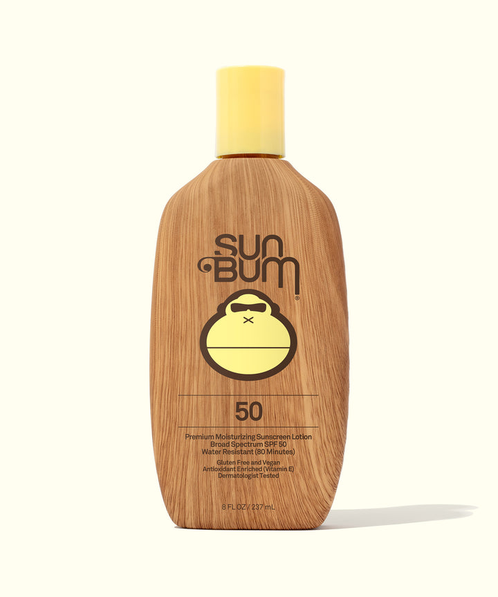 Original SPF 50 Sunscreen Lotion bottle with a wooden look and a yellow cap, featuring Sun Bum branding and a cute monkey logo, Sun Bum