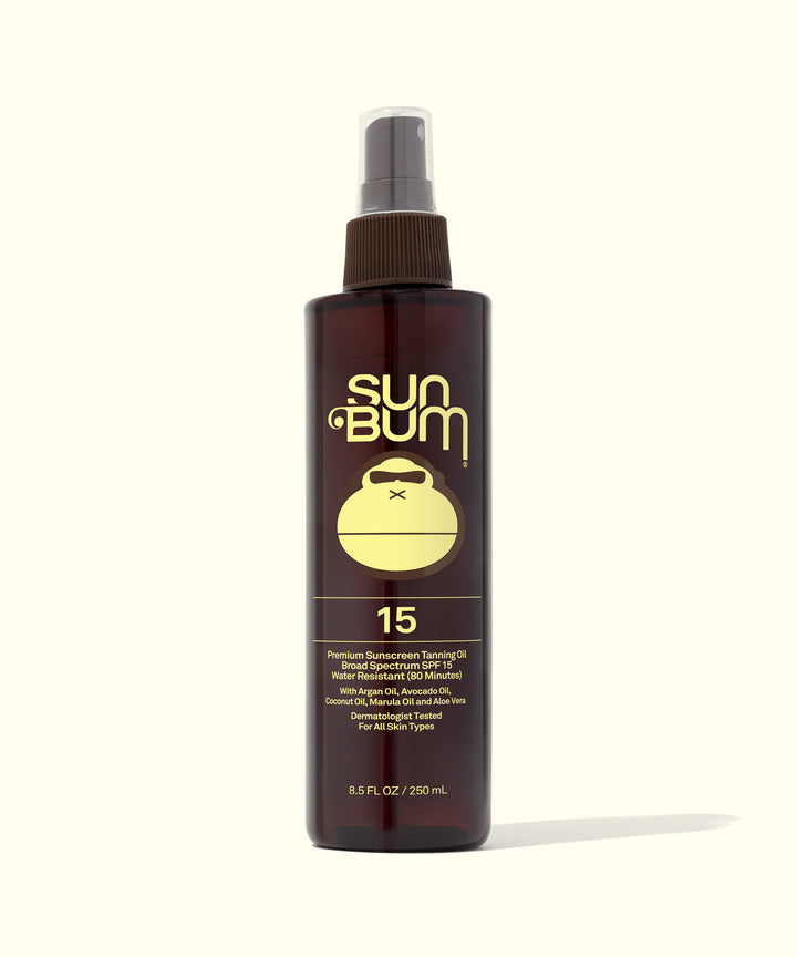 SPF 15 Sunscreen Tanning Oil bottle, perfect for achieving a golden tan while keeping skin silky smooth and protected. Sun Bum