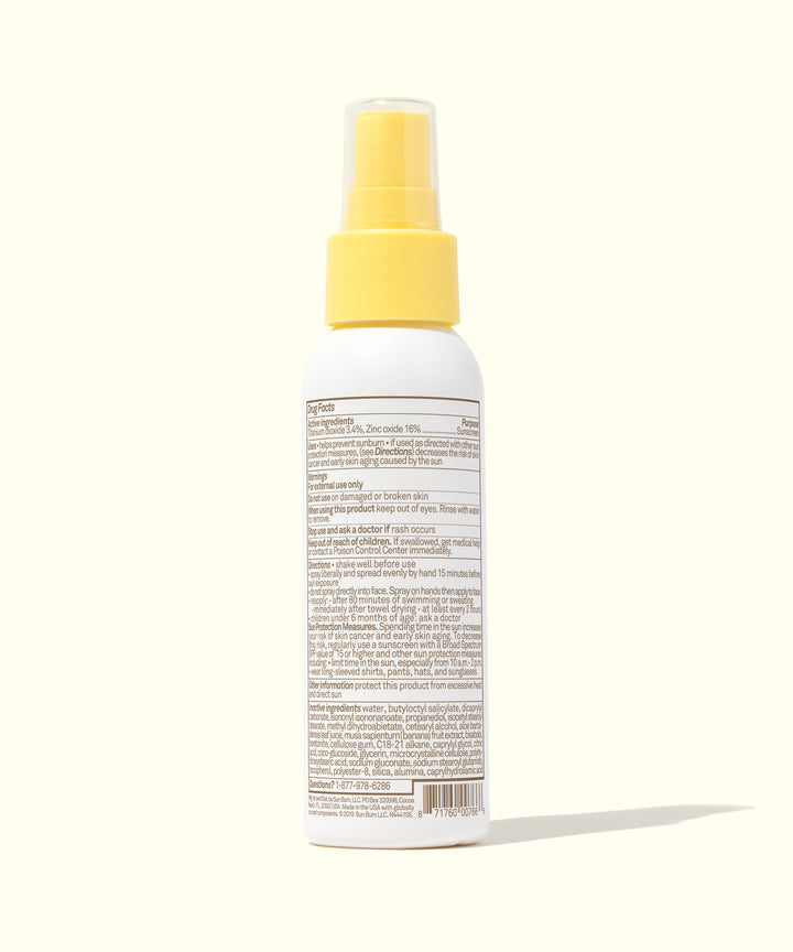 Rear view of Baby Bum Mineral SPF 50 Sunscreen Spray bottle, featuring a yellow cap and product information on the label, Baby Bum.