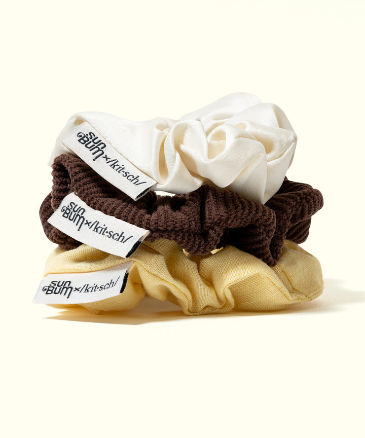 Limited Edition SB x Kitsch 3-piece Scrunchie Set in white, brown, and yellow with branded labels, Sun Bum