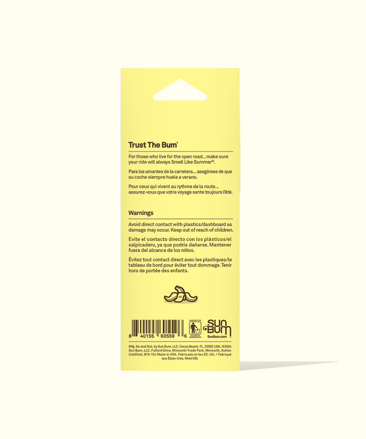 Yellow product packaging for Banana Air Freshener showing multilingual warning text and instructions, featuring a small banana icon and Sun Bum logo at bottom. Perfect for keeping your car smelling like summer. By Sun Bum.