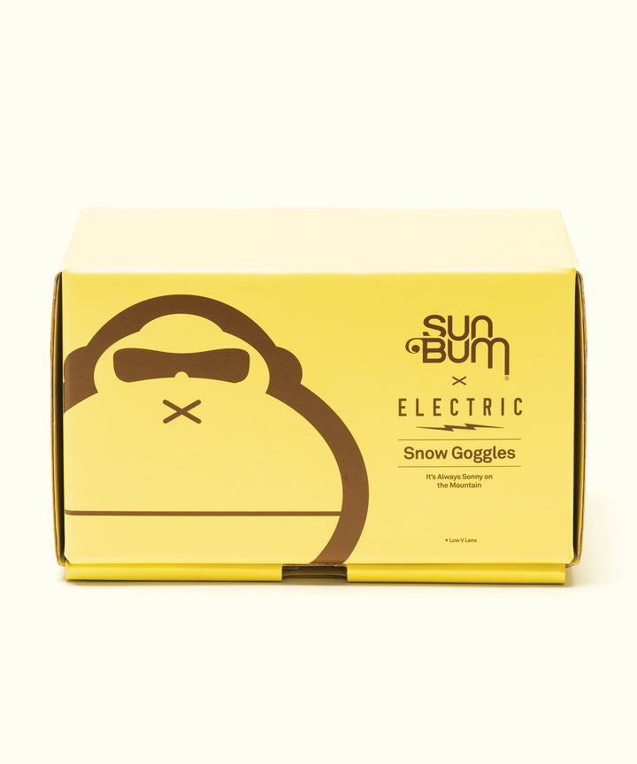 Yellow product box featuring Sun Bum X Electric Snow Goggles collaboration, with brown monkey logo wearing goggles against a bright background. Premium snow eyewear for mountain protection by Sun Bum.